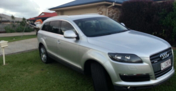 Audi Q7 parked in front yard