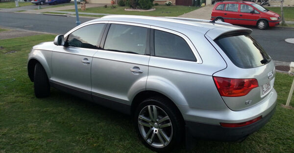 Audi Q7 - Silver Silver Audi Q7 parked on the grass in front yard