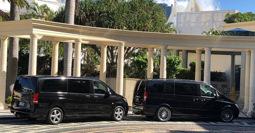 two black mercedes executive vans parked