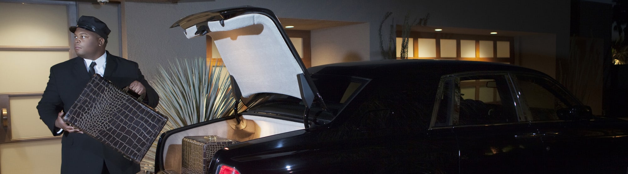 Chauffeur Loading Luggage In Car