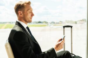 businessman waiting for flight at airport