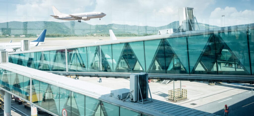 view out of airport windows, take off the flight with  sunny sky