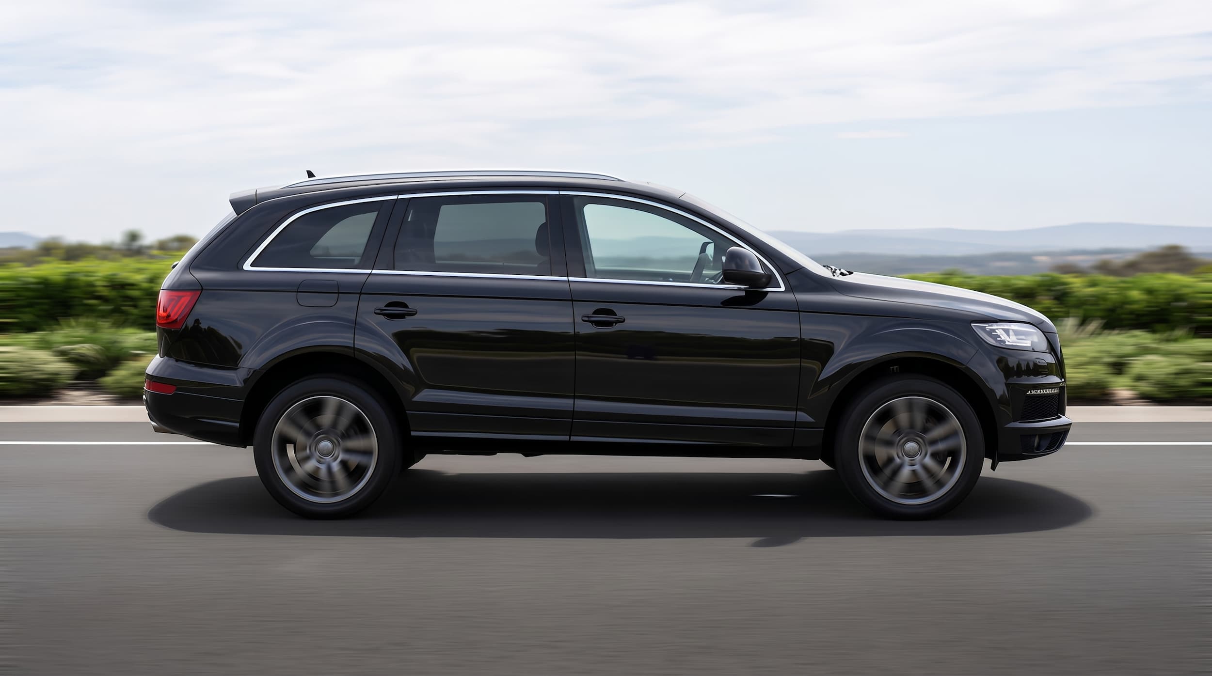 Black Audi Q7 luxury SUV chauffeur car, side profile view